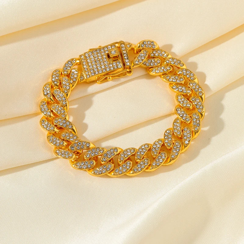 Gold chain bracelet with clear stones on a beige background