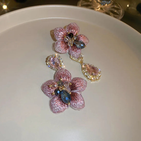 Asymmetric crystal drop earrings with flower and water drop design in zinc alloy for women