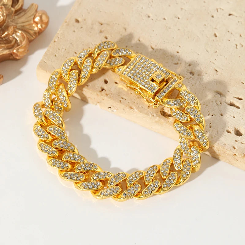Gold chain bracelet with diamond accents on a textured surface