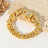 Gold chain bracelet with diamond accents on a textured surface