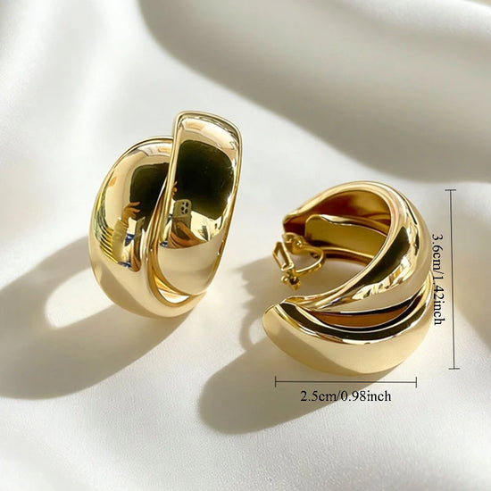 Gold crisscross wide hoop clip-on earrings with C-shaped chunky design for non-pierced ears