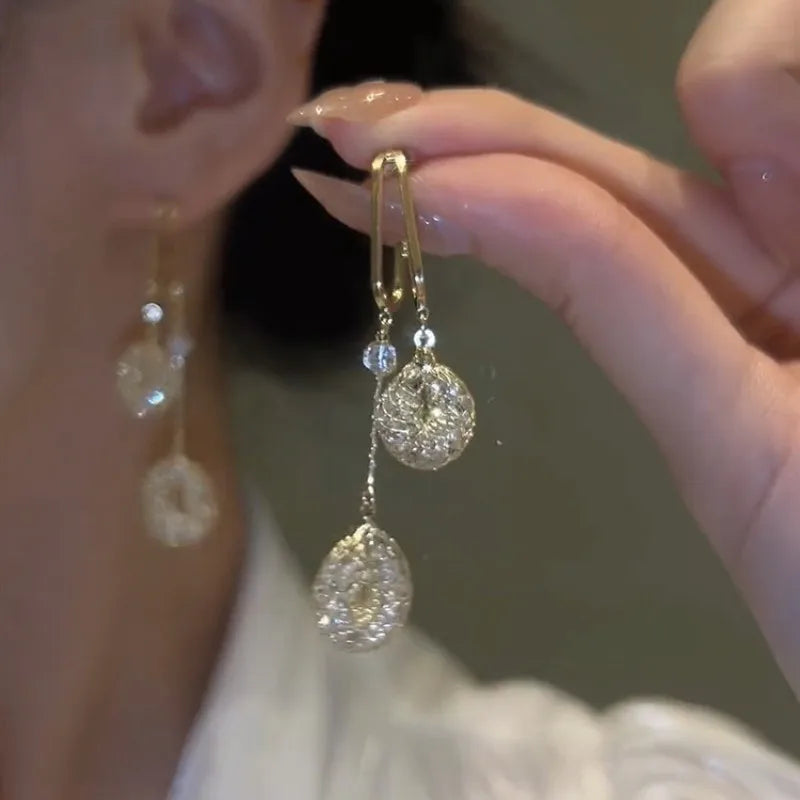 925 silver needle drop earrings with hollow water drop shape, long tassels, and simulated pearl detail