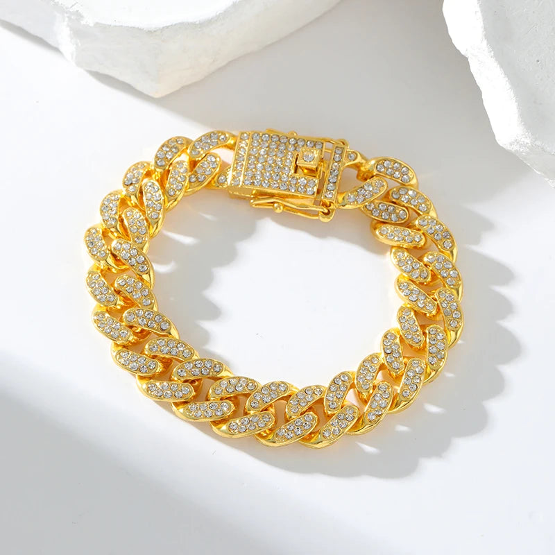 Gold chain bracelet with diamond-like stones on a white background
