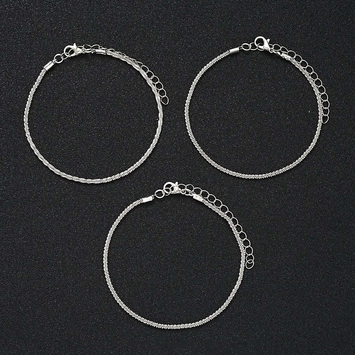 5-piece boho anklet set with metal chains, faux pearls, and butterfly, star, and heart pendant charms